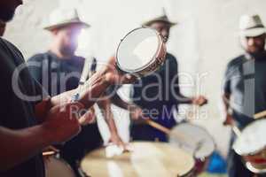 These are the beats of Brazil. Closeup shot of a musical performer playing drums with his band.