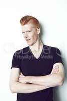 Mr Cool. An trendy redheaded man posing in front of a white background.