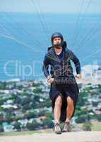 Prepare for takeoff. Shot of a man paragliding on a sunny day.