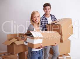 So glad we made the move. Shot of a happy young couple on their moving in day.