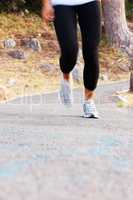 Woman jogging. Low section of woman jogging on pathway.