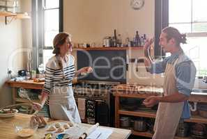 Count the memories not the calories. Shot of a young couple making small balls of dough.