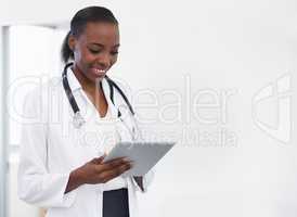 Using technology to make a diagnosis. Shot of a female doctor holding a digital tablet.