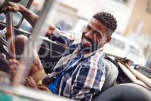 I pledge to drive safely. Shot of a happy young man driving in his convertible.