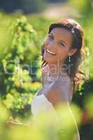 Beaming bride. A gorgeous bride smiling while standing in a vineyard.