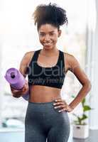 Be the energy you want to attract. Cropped shot of an attractive young woman holding her yoga mat.