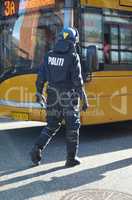 Crowd control. Rearview shot of a police man in riot gear.