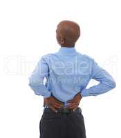 Feeling the effects of sitting all day. Rearview studio shot of an african american businessman holding his lower back in pain.