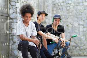 Just chilling between tricks. A group of young bmx riders relaxing together.