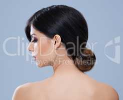 Hair and beauty unmatched. Rear view shot of a stunning brunette woman with her hair in a bun.