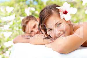 Enjoying being pampered together. Beautiful young woman enjoying a spa day with her partner.