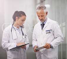 Take a look at this.... Cropped shot of a mature doctor using his digital tablet to teach a female colleague.