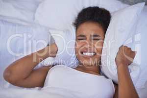 Nothing is going to make me get up today. Cropped shot of a restless young woman lying in bed.