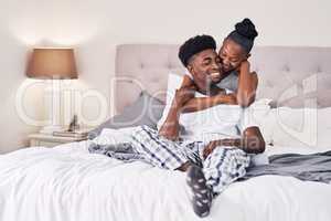 I knew the moment I met her that shes the one. Shot of an affectionate couple relaxing on their bed wearing pajamas.