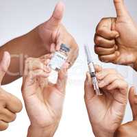 Nurturing yourself is not selfish. Studio shot of a group of people showing thumbs up and holding the vaccine against a grey background.