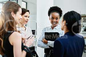 Enthusiasm is the backbone of every successful business. Shot of businesswoman standing together while discussing business in the office.