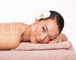 Pamper yourself. A beautiful young woman relaxing on a massage table before her massage.