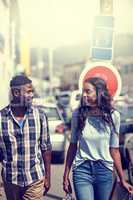 The first duty of love is to listen. Shot of a happy couple walking through an urban area.