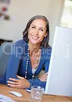 The smile of job satisfaction. Portrait of a mature female design professional sitting at her office desk.