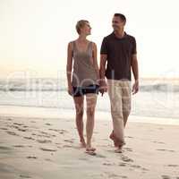 They love long walks on the beach. Shot of a mature couple taking a walk on the beach.