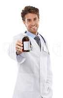 If you want that cough to go away.... Studio shot of a positive-looking young doctor holding bottle up to the camera.