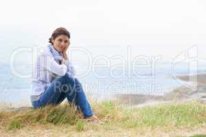 Isnt the view breathtaking. Portrait of a mature woman taking a break from her walk to take in the scenery.