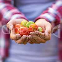 Shes got health in her hands. Cropped shot of a woman holding a handful of fresh strawberries.