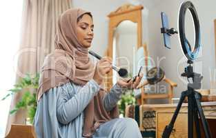 Make-up tips for this years Eid celebrations. Shot of a young muslim female busy recording her for her vlog.