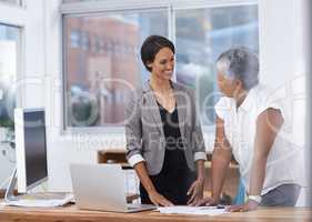 Good relationships in the workplace is key. Shot of two female coworkers having a discussion in the office.