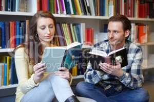Her intelligence is mesmerizing. Shot of a young man and woman bonding over their love for books.