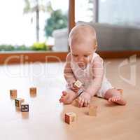 Learning and growing everyday. Shot of a cute and adorable baby boy at home.