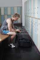 That was a good session. Crppped shot of a young man in the gym after a solid workout.