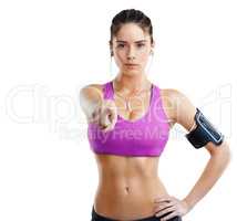 Suck it up or youll be sucking it in. A fit young woman pointing towards you while wearing an mp3 arm band isolated on white.