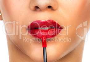 Put on some red lipstick and live a little. Cropped shot of an unrecognizable woman applying red lipstick to her lips.