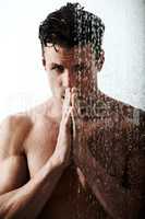 Cleansing his body and his mind. Shot of a handsome man taking a shower.