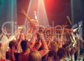 A young man crowd surfing to his favorite band. This concert was created for the sole purpose of this photo shoot, featuring 300 models and 3 live bands. All people in this shoot are model released.