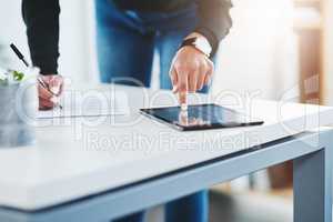 Tapping in to new markets. Closeup shot of a businesswoman working on a digital tablet in an office.