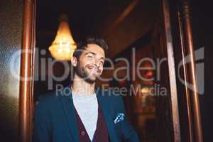 Dressed to impress. Cropped shot of a young man standing in a bar.