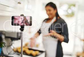 I have so much to share on baking. Cropped shot of a woman being recorded on a cellphone while baking in the kitchen.