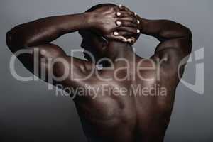 Solid as a rock. A handsome and muscular young man posing in the studio.