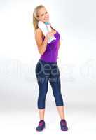 I feel and look awesome. Studio shot of a fit young woman in gym clothes drinking staying hydrated.