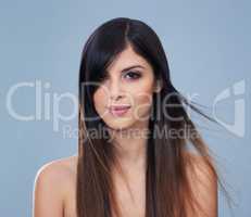 Hair and beauty unmatched. Studio shot of a beautiful brunette model with gorgeous long hair.