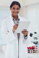 Shes considered as a leading expert in the scientific field. Portrait of a young female scientist working in a lab.