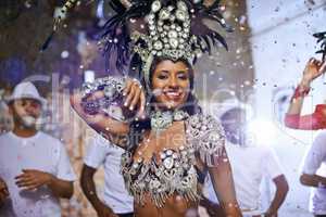 Fine feathers make fine birds. Portrait of an attractive female Mardi Gras performer in a feather headdress.