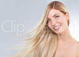 Blonde and beautiful. Studio portrait of a young woman with long blonde hair.