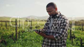 Farming just got a whole lot more efficient. Shot of a mature man using a digital tablet while working on a farm.