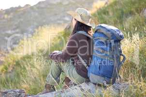 Taking in the beautiful scenery. A young hiker with her backpack looking out at the scenery.