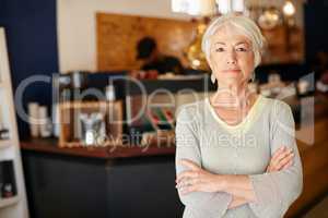 I invested in a small business after retirement. Portrait of a senior woman working in a coffee shop.