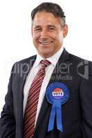 Im the right man for the job. Portrait of a man in a suit with a voting ribbon on a white background.