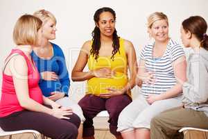 Discussing their hopes and dreams. A group of pregnant women sitting down together to share their feelings.